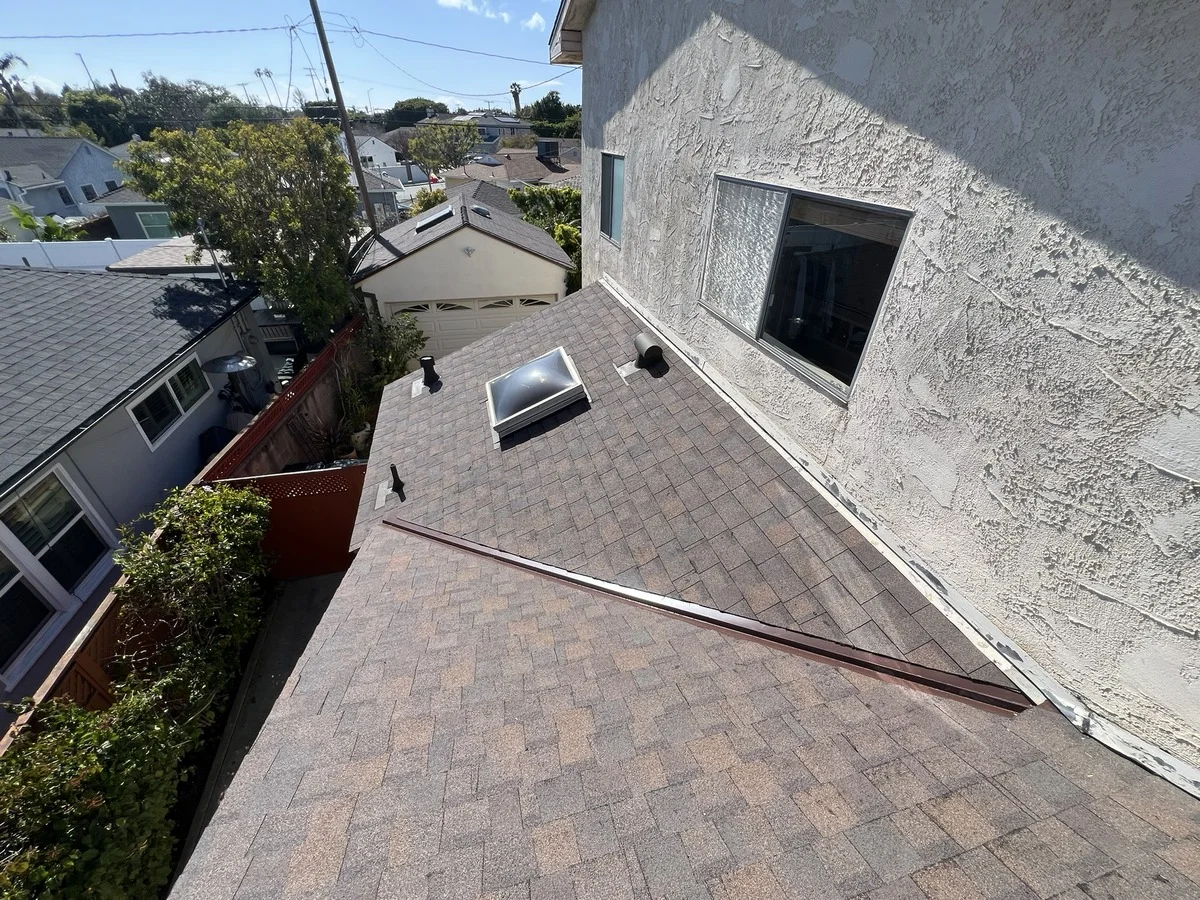 Blue Skyline Roofing crew securing an emergency tarp over a leaking roof in Los Angeles