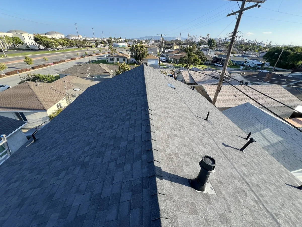 Blue Skyline Roofing crew securing an emergency tarp over a leaking roof in Los Angeles