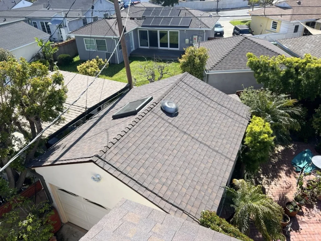 Blue Skyline Roofing crew securing an emergency tarp over a leaking roof in Los Angeles