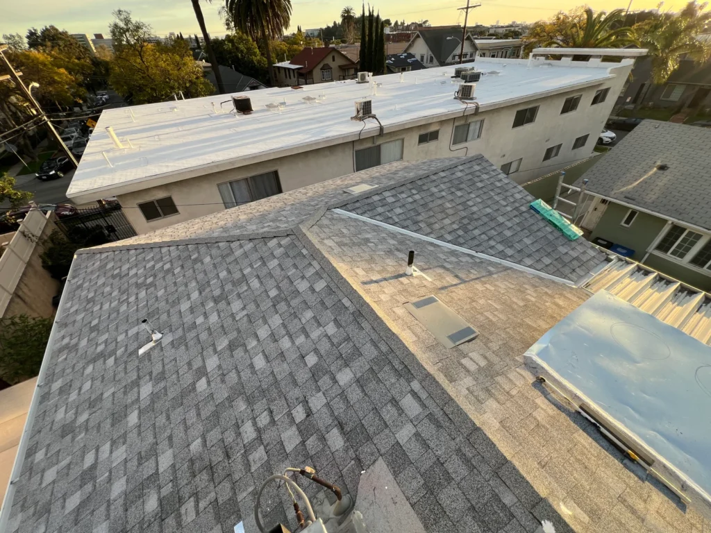 Blue Skyline Roofing crew securing an emergency tarp over a leaking roof in Los Angeles