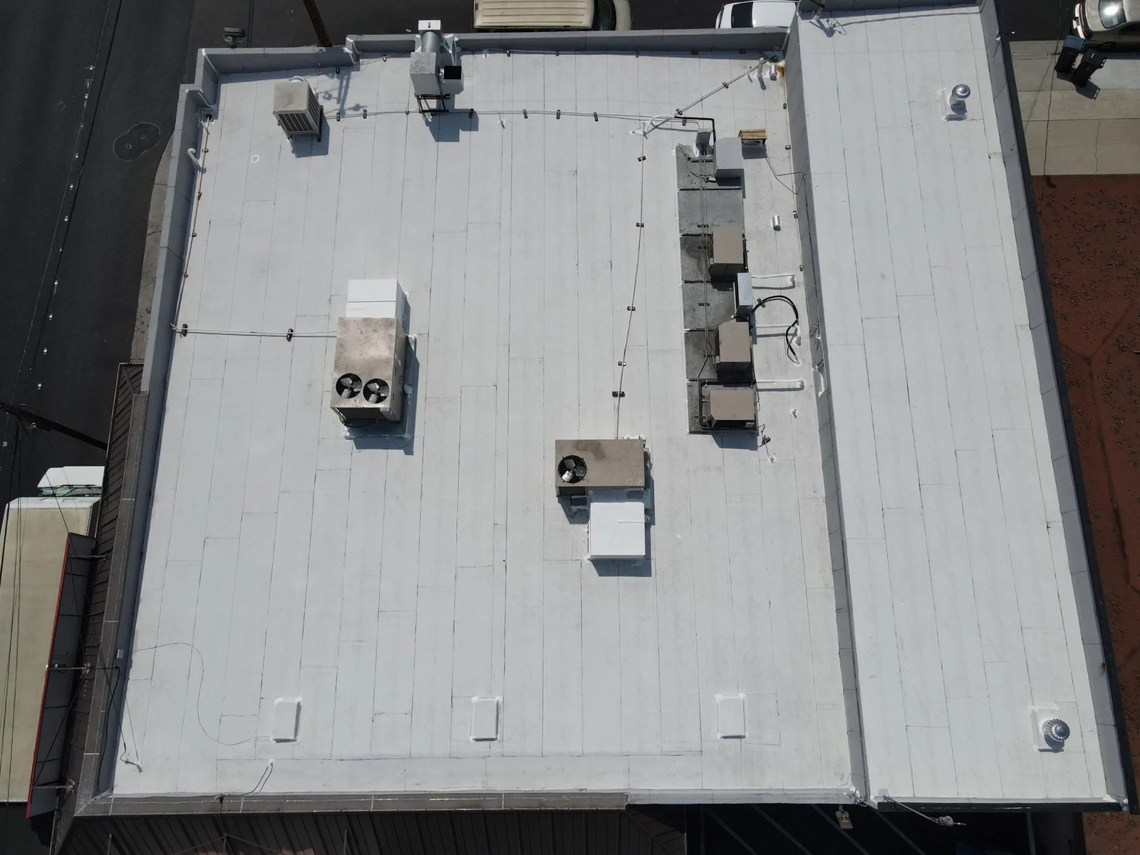 Blue Skyline Roofing crew securing an emergency tarp over a leaking roof in Los Angeles
