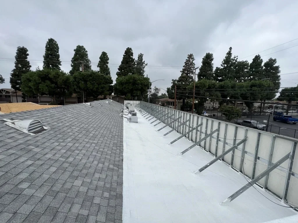 Blue Skyline Roofing crew securing an emergency tarp over a leaking roof in Los Angeles