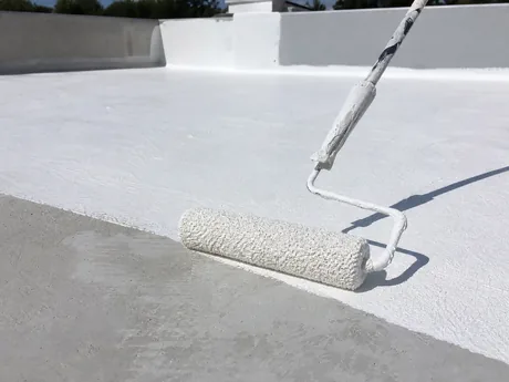 Crew coating a flat commercial roof in Torrance's industrial district