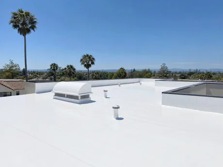 Blue Skyline Roofing crew replacing the torch down roof on a Gardena fourplex with tenants in place